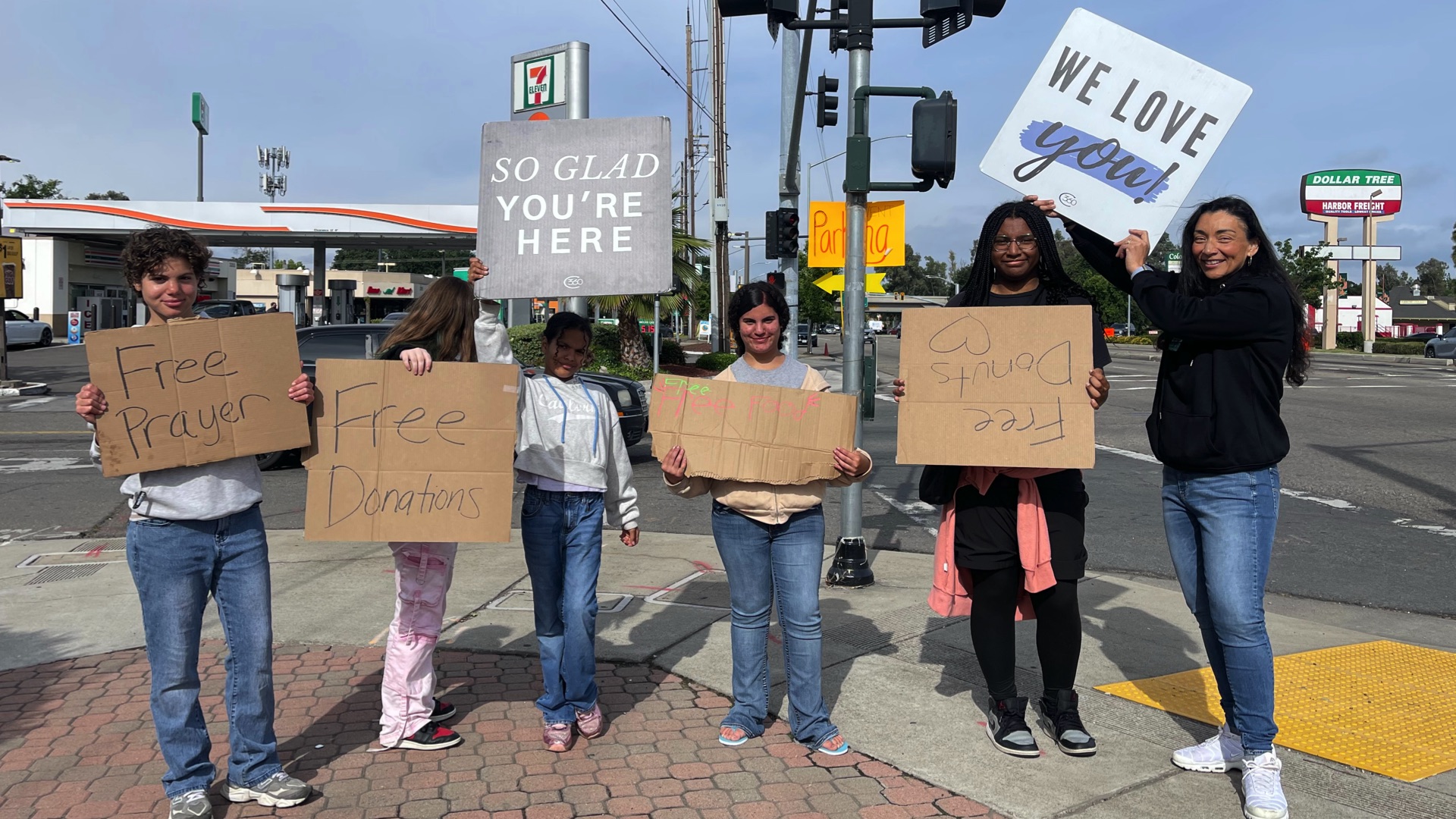 A group of church members standing with signs of love